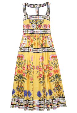 Yellow t-strap long dress with pink, white, black, purple printed flower detail. Set against a checkered background.