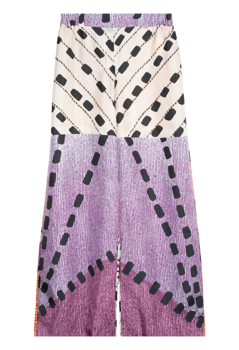Pattern silk pant. Pattern includes lavender  print darker purple print and white print. Black dotted lines throughout pant. Purple elastic waistband. Photo taken on transparent background