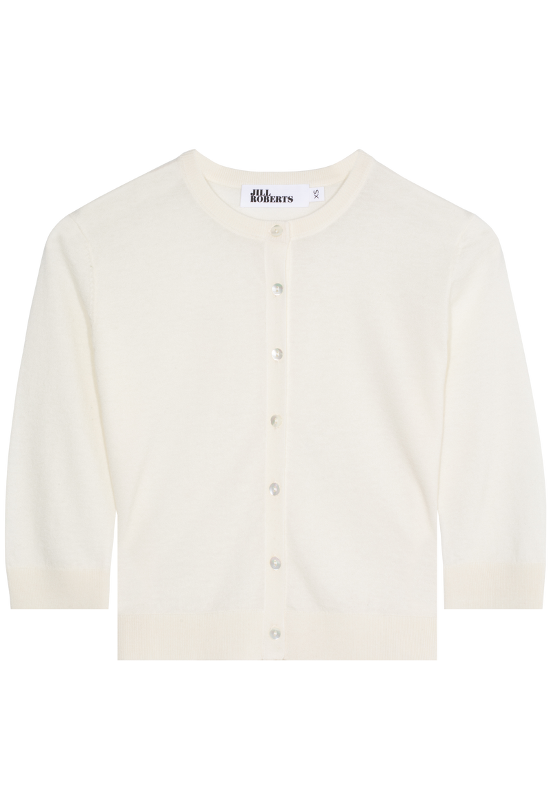 An eggshell cashmere cropped cardigan with seven shiny white buttons and 3/4 sleeves. Transparent background.
