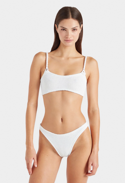 a woman wearing a white bikini with crinkle fabric. white background.