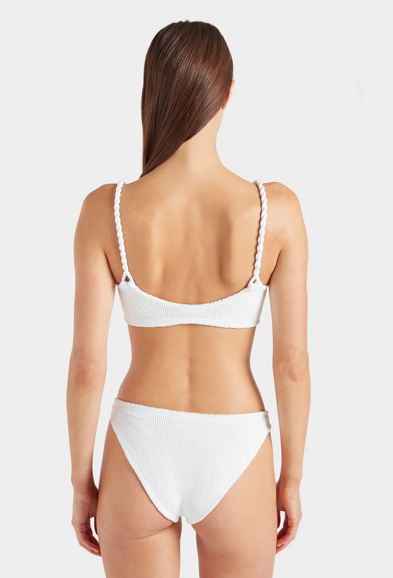 the back of a woman wearing a white bikini with crinkle fabric. white background.