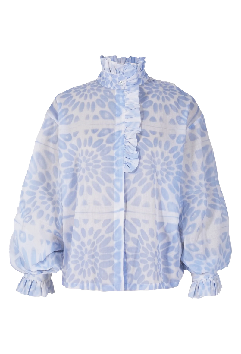 a white blouse with a blue floral print and a ruffled neck and sleeves. transparent background.