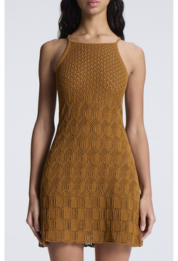 a woman wearing a golden brown high neck crocheted mini dress. white background.