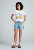 a woman wearing a white graphic t-shirt and light denim shorts with two large patch pockets. white background.