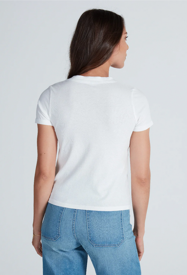 the back of a model wearing a v-neck mock henley t-shirt with jeans. white background.