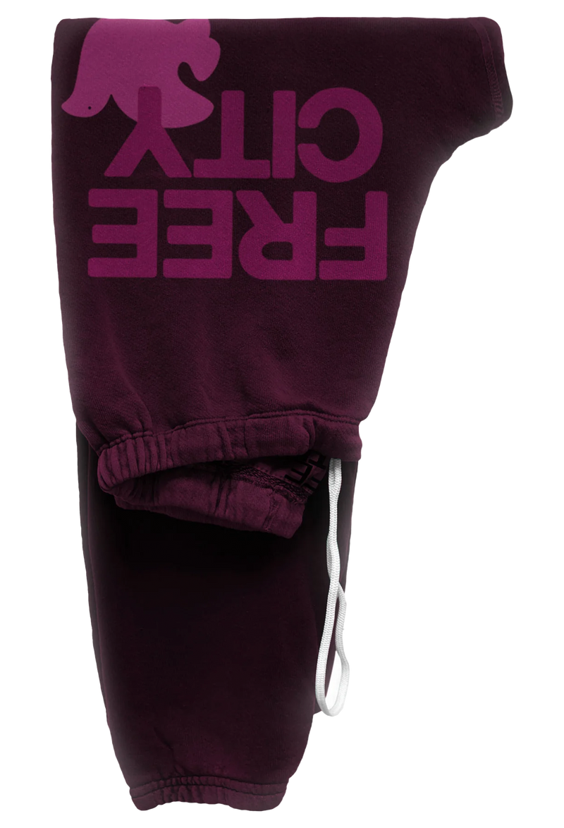 eggplant sweatpant with classic "FREECITY" print in magenta and tonal light pink "FREECITYDOVE," covered elastic waist and pull drawcord. transparent background