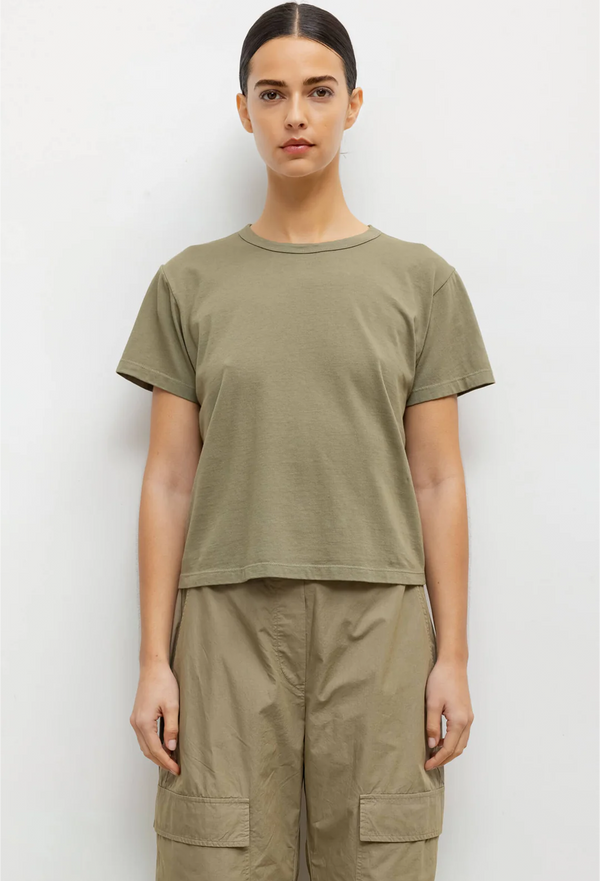 a model wearing an army green short sleeve t-shirt and matching pants. white background.