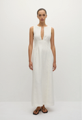 a model wearing a sleeveless deep v-neck white maxi dress with a fitted bodice and slightly flared skirt. white background.