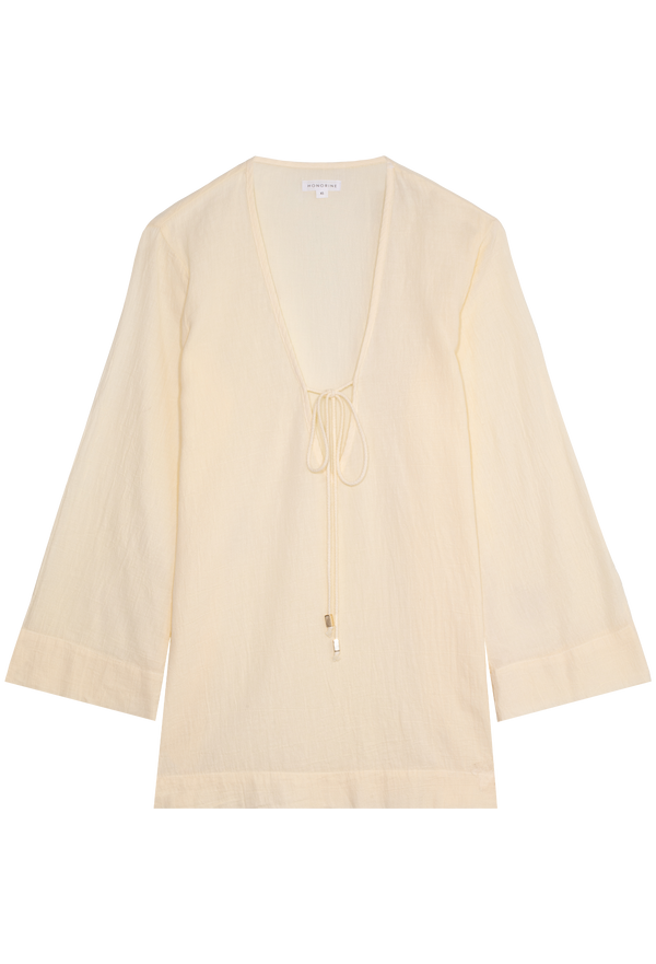 a light yellow deep v-neck mini coverup with long sleeves and a tie at the bust. transparent background.