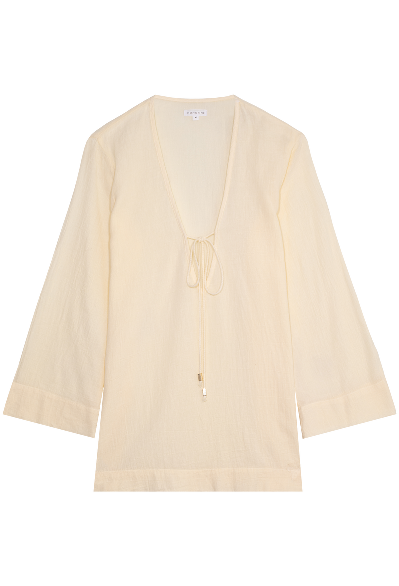 a light yellow deep v-neck mini coverup with long sleeves and a tie at the bust. transparent background.