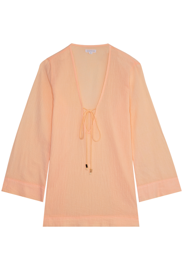 a melon colored deep v-neck mini coverup with long sleeves and a tie at the bust. transparent background.