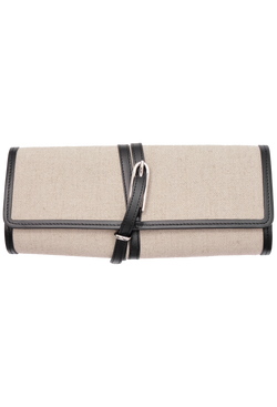 an off-white canvas belted clutch with black leather trim and a silver buckle on a transparent background.