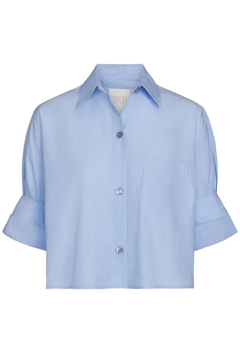 Light blue cropped button down shirt with rolled short sleeves on a transparent background