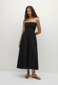 model wearing a black strapless midi dress on a white background