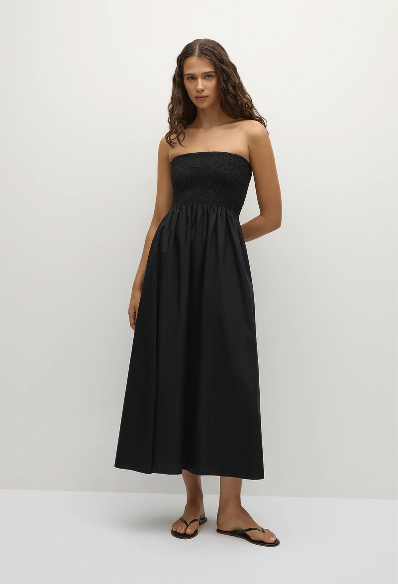 model wearing a black strapless midi dress on a white background