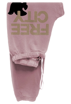 light pink sweatpants with golden 'FREECITY' text and black dove logo on a transparent background