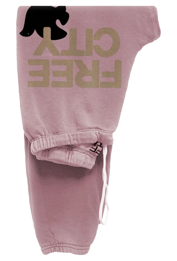 light pink sweatpants with golden 'FREECITY' text and black dove logo on a transparent background