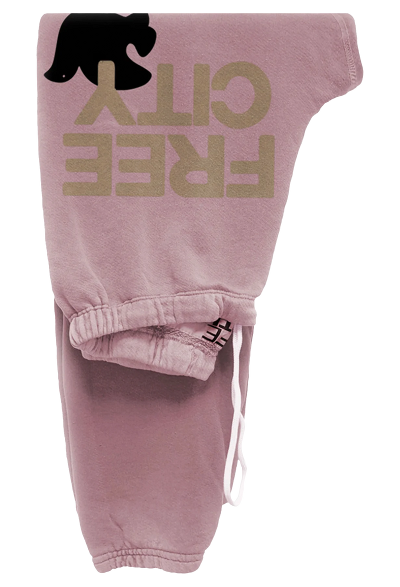 light pink sweatpants with golden 'FREECITY' text and black dove logo on a transparent background