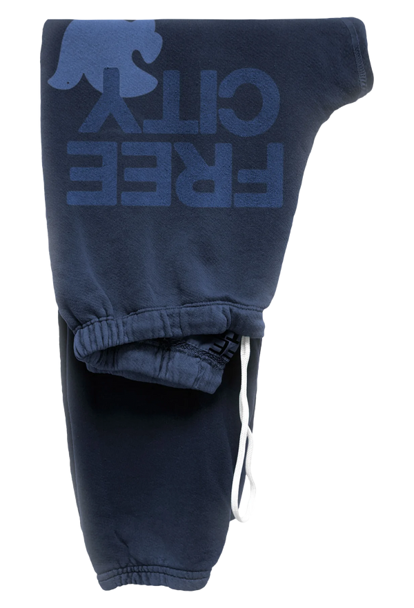 dark blue sweatpants with blue 'FREECITY' text and light blue dove logo on a transparent background