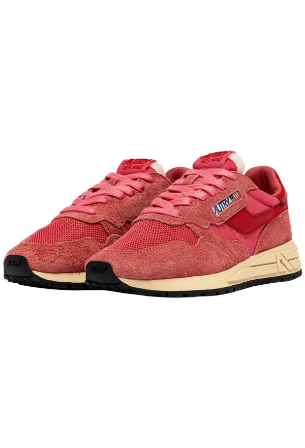 pink and red athletic tennis shoes with a black bottom