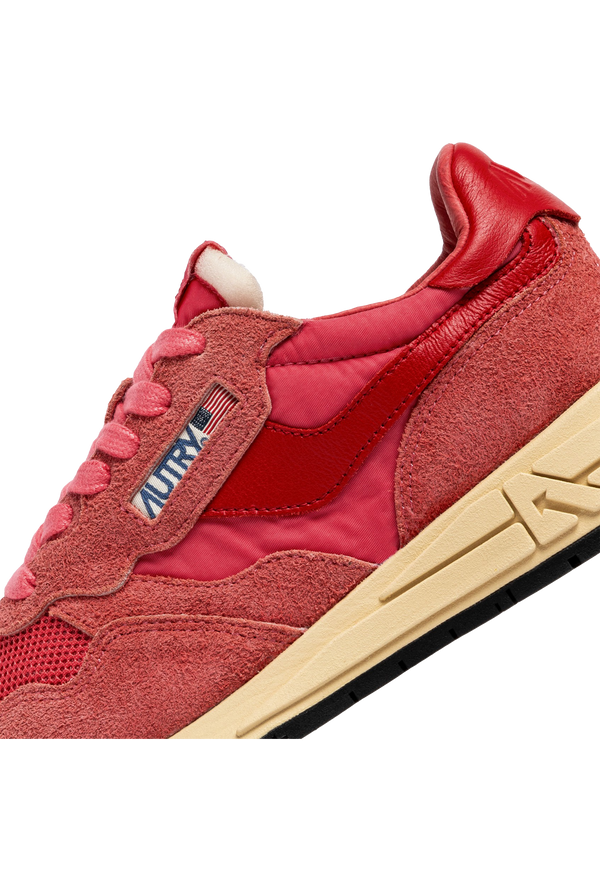 pink and red athletic tennis shoes with a black bottom