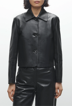 Black leather jacket worn by a person on a white background