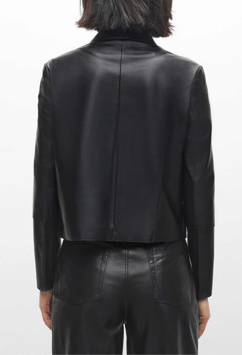 Black leather jacket worn by a person on a white background