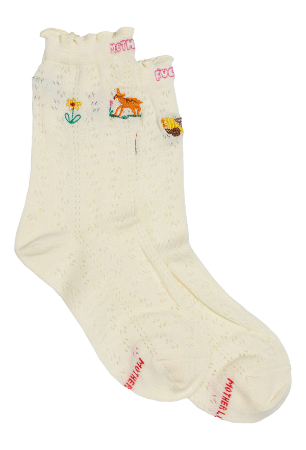 Pair of cream socks with colorful embroidered designs on a white background