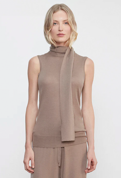 Woman wearing a brown sleeveless top with a scarf on a white background