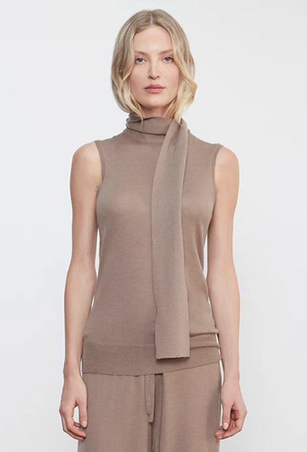 Woman wearing a brown sleeveless top with a scarf on a white background