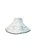 Reversible hand painted bucket hat, white with blue painted designs and blue rim. Set against black checkered background.