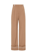 Long tan pant, cuffed at the bottom with white belt loops. Set against a white background.